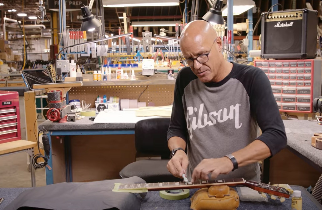 Gibson Master Luthier Jim DeCola cleans and oils a Gibson Les Paul fretboard.