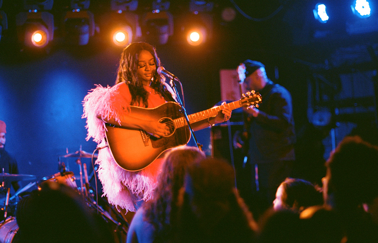 Ayoni on stage with her Gibson acoustic guitar