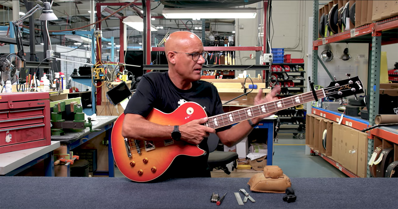 Jim DeCola sets up a Gibson bass guitar